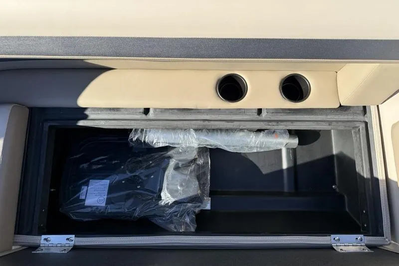 Slide: The Image of Storage compartment in 2026 Premier 220 Sunscape RF XLC boat, featuring dual cup holders. - 14