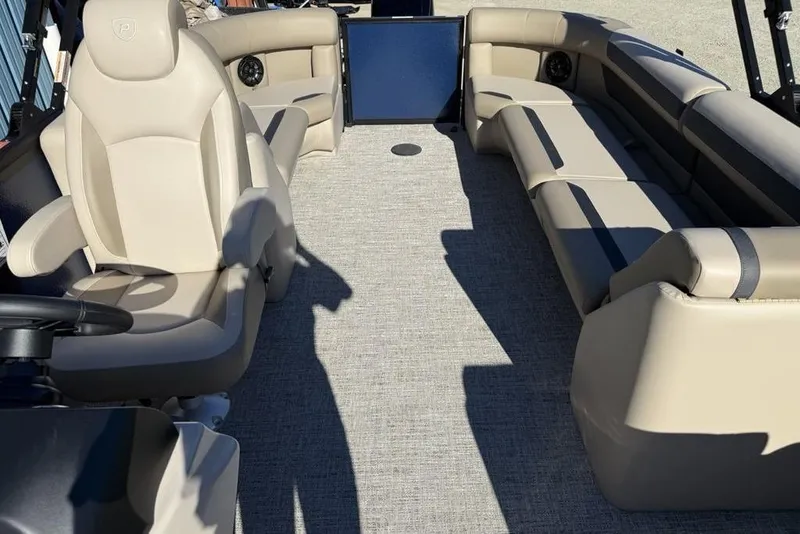 Slide: The Image of 2026 Premier 220 Sunscape RF XLC boat interior with beige seating and carpeted floor. - 16