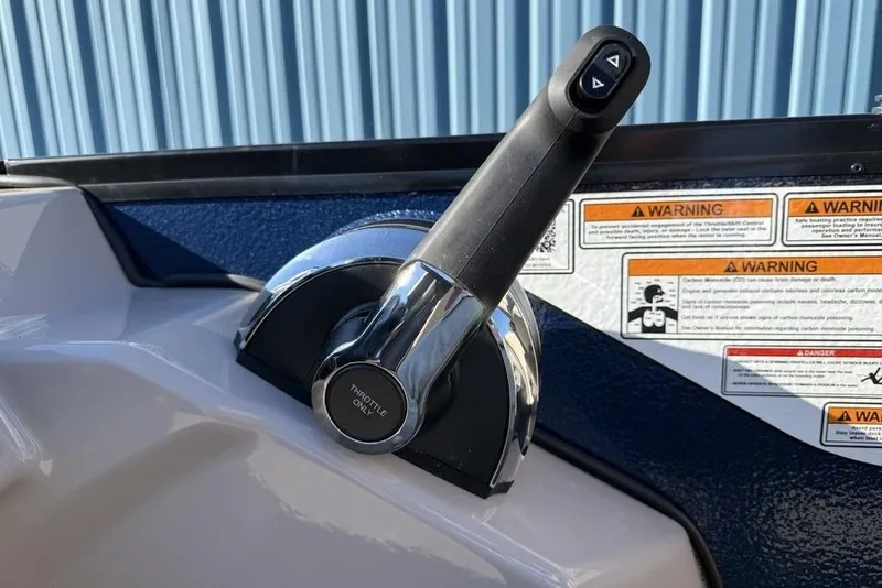 Slide: The Image of Throttle control of 2026 Premier 220 Sunscape RF XLC boat with warning labels. - 19