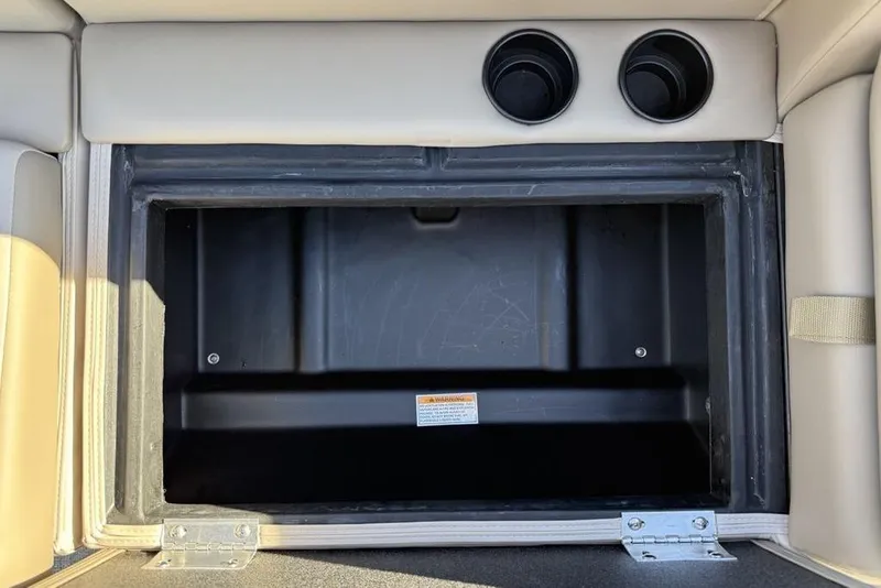 Slide: The Image of Storage compartment in 2026 Premier 220 Sunscape RF XLC boat, featuring cup holders. - 20