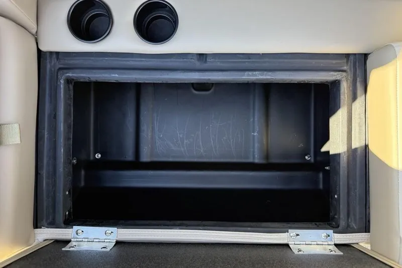 Slide: The Image of Storage compartment in 2026 Premier 220 Sunscape RF XLC boat, featuring cup holders. - 25