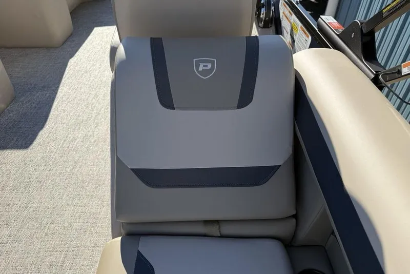 Slide: The Image of 2026 Premier 220 Sunscape RF XLC boat seat with logo, featuring beige and gray upholstery. - 26