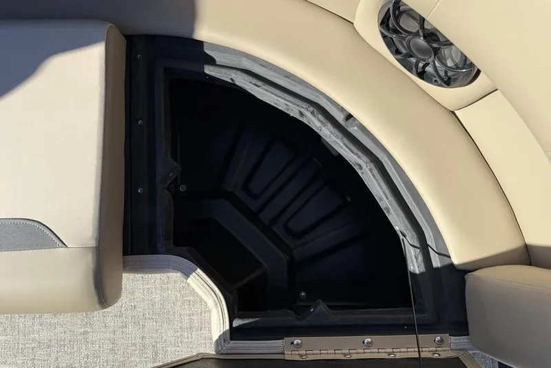 Slide: The Image of Storage compartment in 2026 Premier 220 Sunscape RF XLC boat with beige seating. - 29