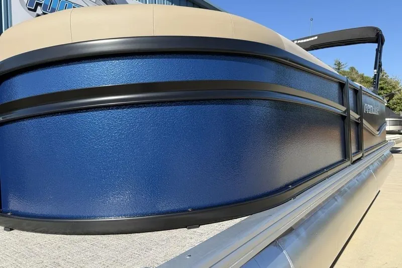 Slide: The Image of 2026 Premier 220 Sunscape RF XLC pontoon boat with blue exterior and beige seating. - 3