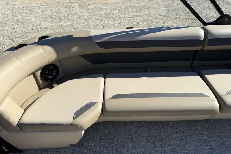 Slide: The Image of Luxurious seating on 2026 Premier 220 Sunscape RF XLC boat, featuring beige upholstery and built-in speaker. - 31