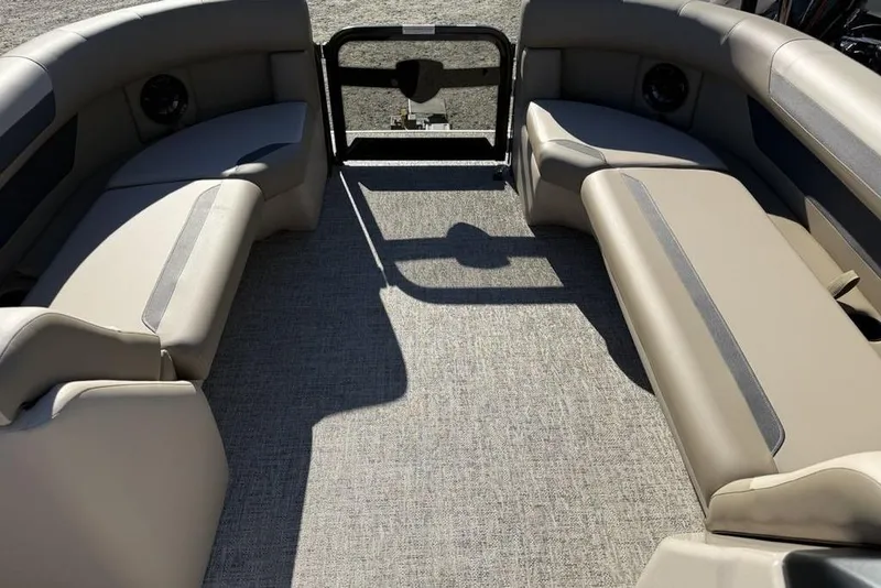 Slide: The Image of 2026 Premier 220 Sunscape RF XLC boat interior with beige seating and carpeted floor. - 8