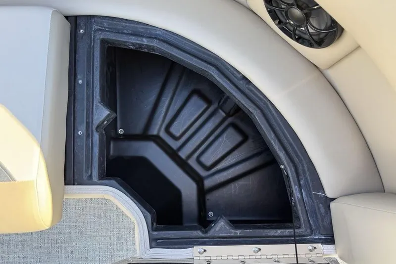 Slide: The Image of Storage compartment in 2026 Premier 220 Sunscape RF XLC boat, featuring sleek design and speaker. - 9