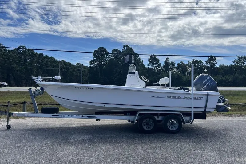 Slide: The Image of 2007 Sea Hunt BX 22 T boat on trailer, parked outdoors under cloudy sky. - 1