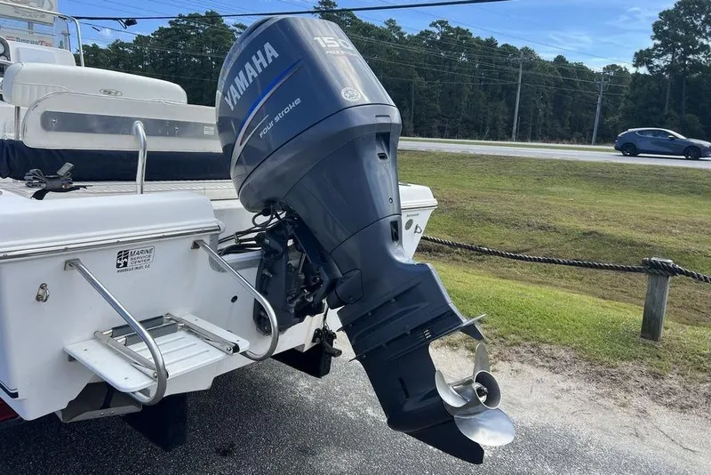 Slide: The Image of 2007 Sea Hunt BX 22 T boat with Yamaha 150 outboard motor, parked on roadside. - 10