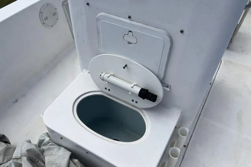 Slide: The Image of 2007 Sea Hunt BX 22 T boat livewell with open lid and plumbing. - 14