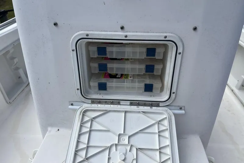 Slide: The Image of Storage compartment on a 2007 Sea Hunt BX 22 T boat with tackle boxes. - 16