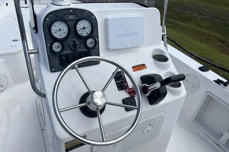 Slide: The Image of 2007 Sea Hunt BX 22 T boat console with steering wheel and gauges. - 6