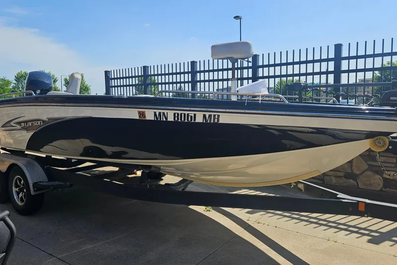 The Image of 2020 Larson FX 2020 Tiller boat on trailer, parked outdoors. - 0
