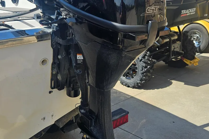 Slide: The Image of 2020 Larson FX 2020 Tiller boat motor, close-up view, parked on concrete surface. - 4