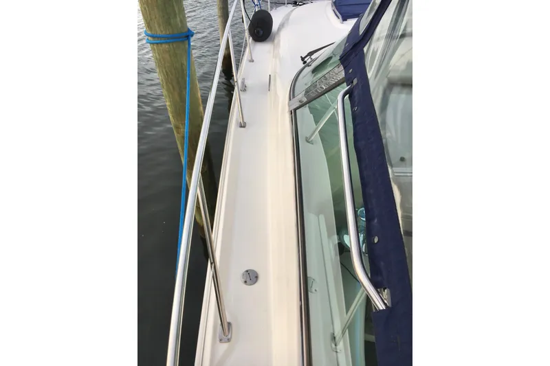 Slide: The Image of 2005 Sea Ray 420 Sundancer yacht deck with railing and docked at marina. - 10