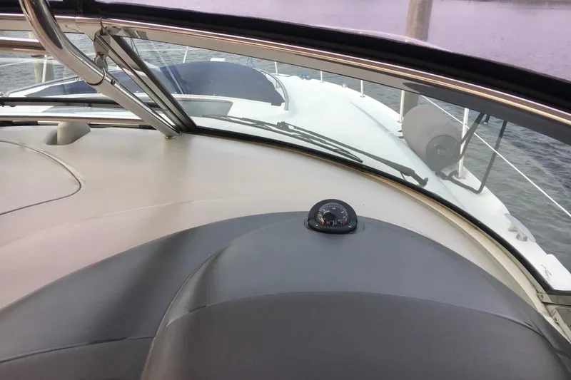 Slide: The Image of 2005 Sea Ray 420 Sundancer cockpit view with compass, overlooking the bow and water. - 13