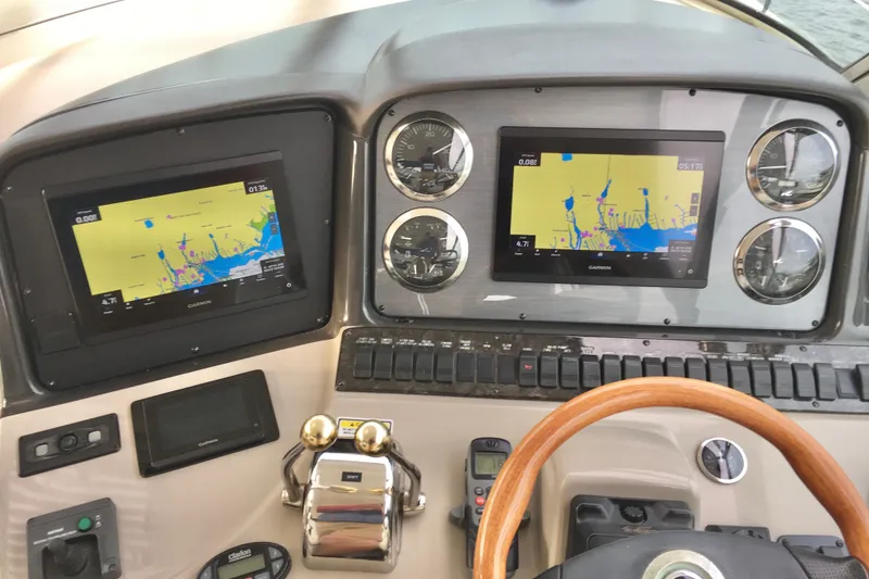 Slide: The Image of Dashboard of 2005 Sea Ray 420 Sundancer with navigation screens and controls. - 15