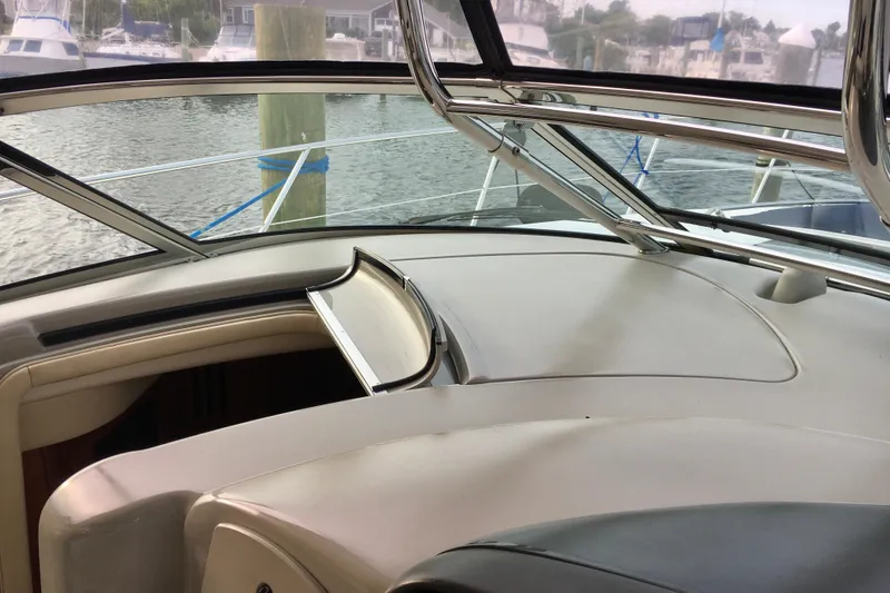 Slide: The Image of 2005 Sea Ray 420 Sundancer cockpit view with marina background. - 20
