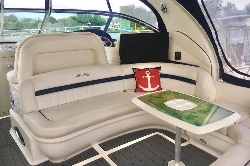 Slide: The Image of Luxurious 2005 Sea Ray 420 Sundancer interior with plush seating and nautical decor. - 23