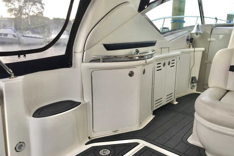 Slide: The Image of Interior of 2005 Sea Ray 420 Sundancer yacht, featuring sleek cabinetry and seating. - 24