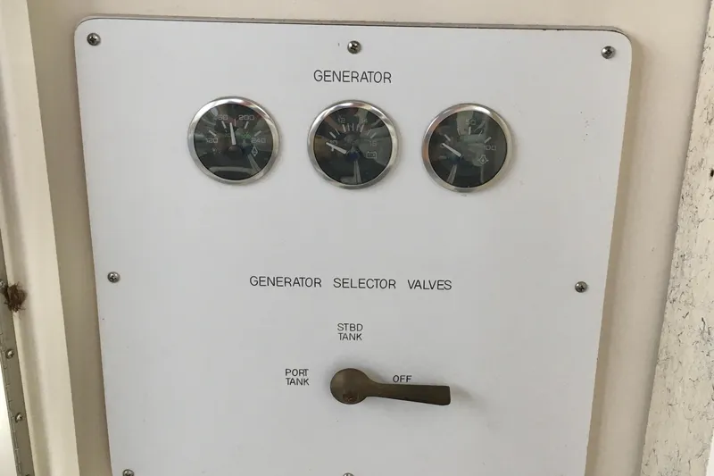Slide: The Image of Control panel of a 2005 Sea Ray 420 Sundancer with gauges and selector valves. - 26