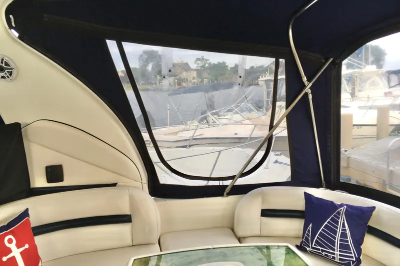 Slide: The Image of Interior of 2005 Sea Ray 420 Sundancer yacht with nautical-themed cushions and marina view. - 30