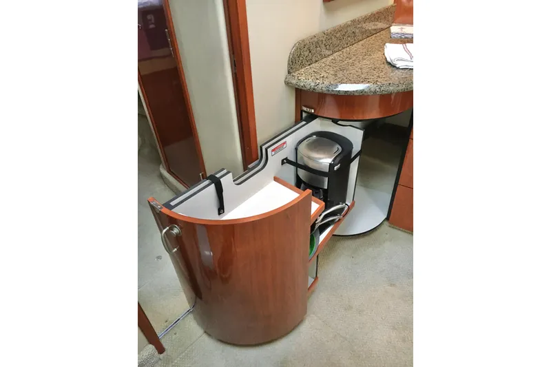 Slide: The Image of 2005 Sea Ray 420 Sundancer interior with pull-out cabinet and coffee maker. - 33
