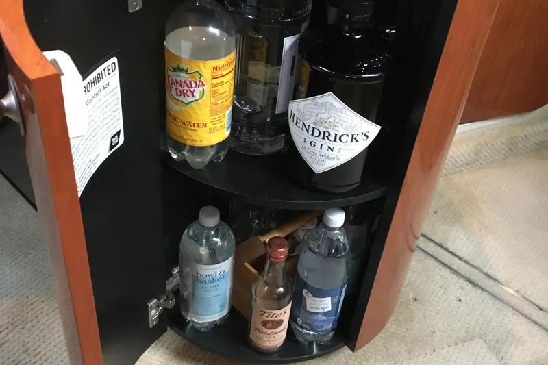 Slide: The Image of Bar cabinet on 2005 Sea Ray 420 Sundancer with assorted beverages and tonic water. - 34