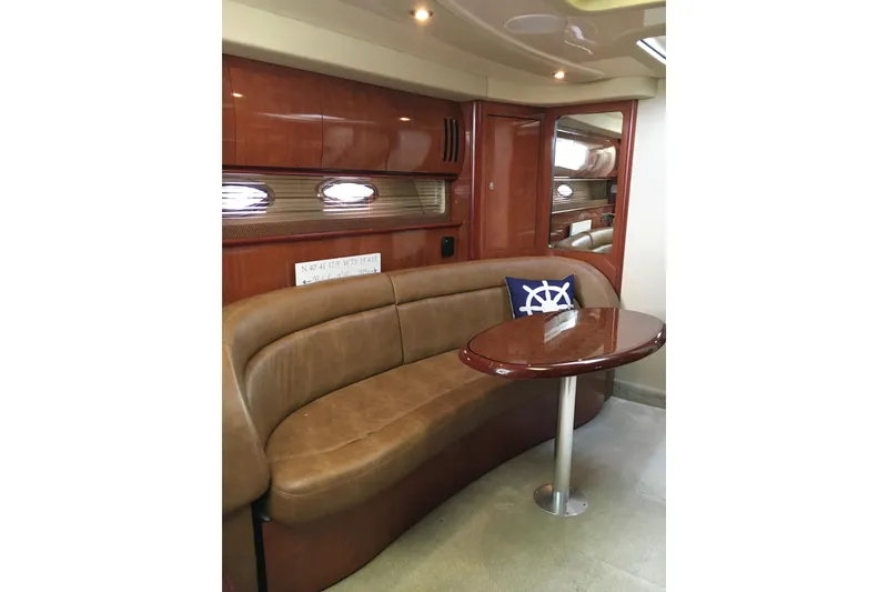 Slide: The Image of Luxurious interior of 2005 Sea Ray 420 Sundancer yacht with leather seating and wooden table. - 35