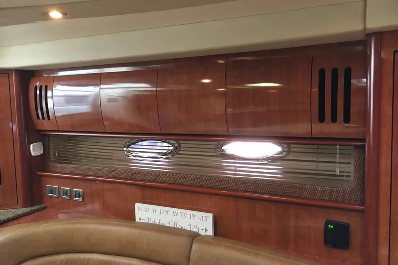 Slide: The Image of Interior of 2005 Sea Ray 420 Sundancer yacht with wood cabinetry and porthole window. - 36