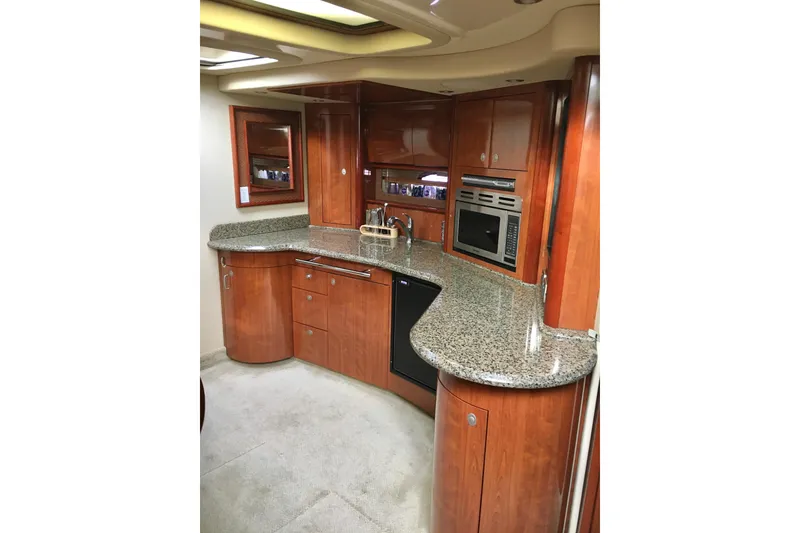 Slide: The Image of Luxurious 2005 Sea Ray 420 Sundancer yacht kitchen with granite countertops and wood cabinetry. - 37