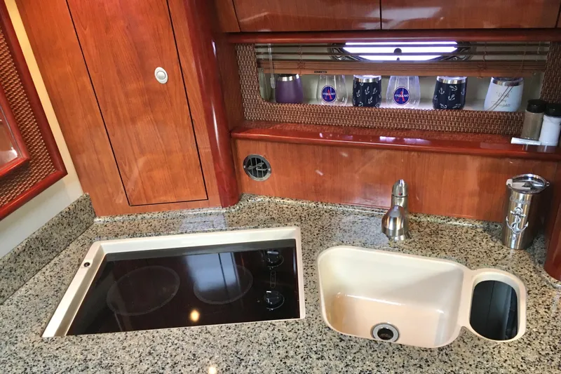 Slide: The Image of Luxurious 2005 Sea Ray 420 Sundancer yacht kitchen with granite countertops and modern appliances. - 38