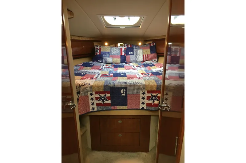 Slide: The Image of Cozy cabin interior of 2005 Sea Ray 420 Sundancer with colorful patchwork quilt. - 40