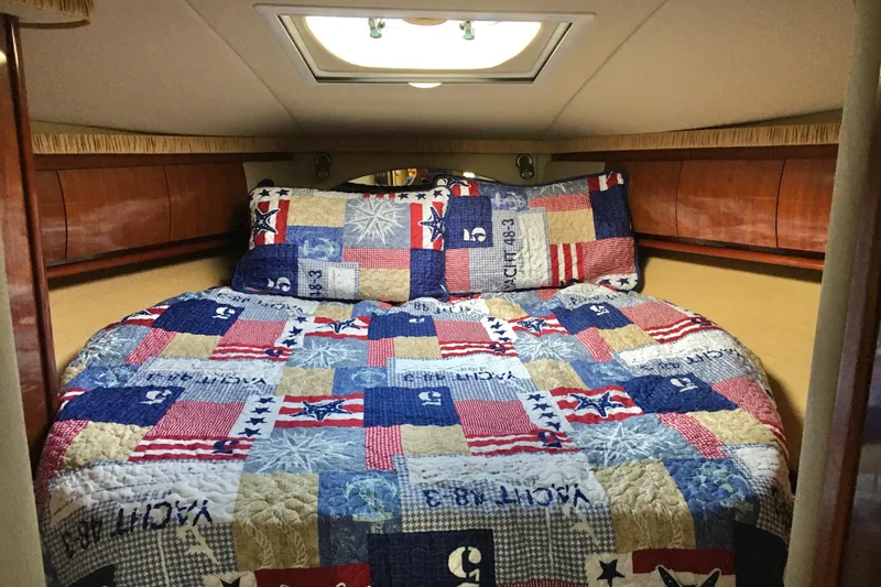 Slide: The Image of Cozy cabin interior of 2005 Sea Ray 420 Sundancer with nautical-themed bedding. - 41