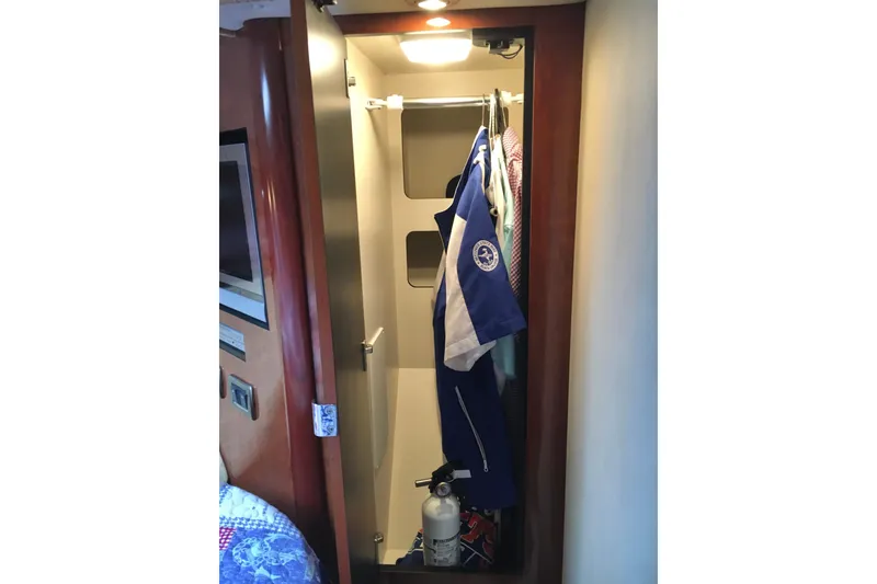 Slide: The Image of Closet interior on 2005 Sea Ray 420 Sundancer yacht with hanging clothes and fire extinguisher. - 44