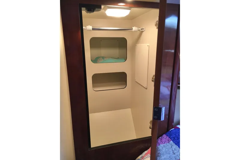 Slide: The Image of Interior closet of 2005 Sea Ray 420 Sundancer yacht with shelves and hanging rod. - 48