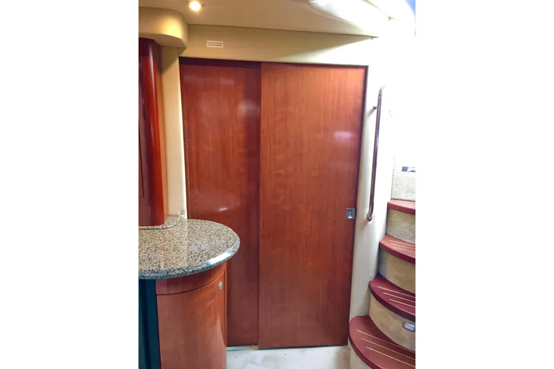 Slide: The Image of Interior of 2005 Sea Ray 420 Sundancer with wooden door and granite countertop. - 51