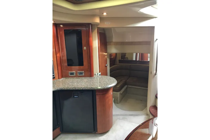 Slide: The Image of Interior of 2005 Sea Ray 420 Sundancer yacht with wood cabinetry and seating area. - 52