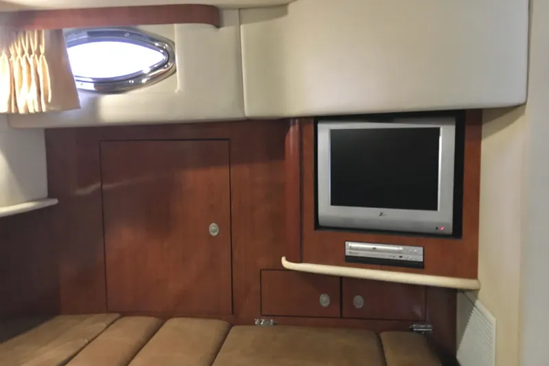 Slide: The Image of Interior of 2005 Sea Ray 420 Sundancer with TV and wooden cabinetry. - 55
