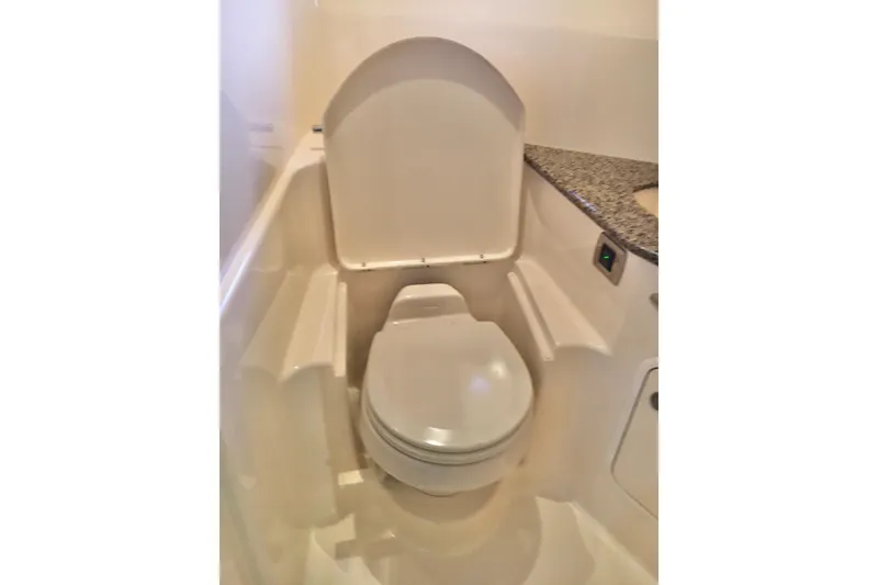 Slide: The Image of 2005 Sea Ray 420 Sundancer yacht bathroom with modern toilet and granite countertop. - 59