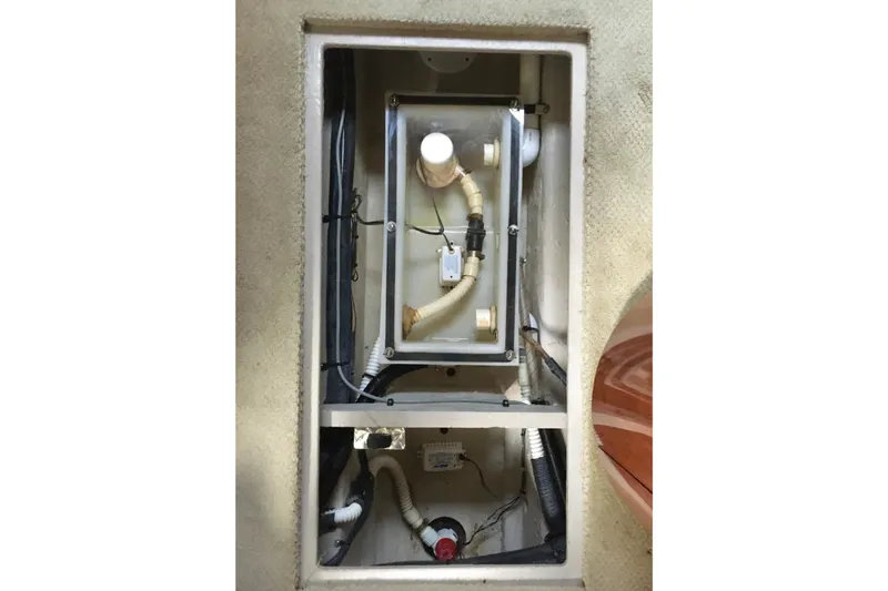Slide: The Image of 2005 Sea Ray 420 Sundancer bilge compartment with visible plumbing and wiring. - 62