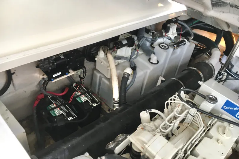 Slide: The Image of Engine compartment of 2005 Sea Ray 420 Sundancer with batteries and Cummins components. - 65