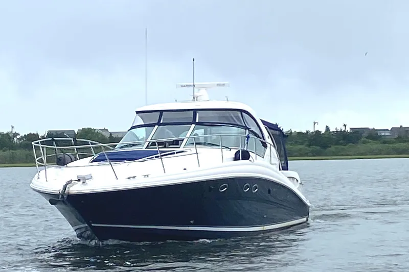Slide: The Image of 2005 Sea Ray 420 Sundancer yacht cruising on calm waters. - 9
