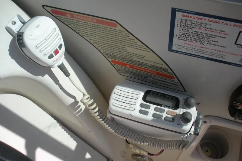 Slide: The Image of VHF radio and microphone on a 2000 Sea Ray 240 Sundancer boat dashboard. - 10