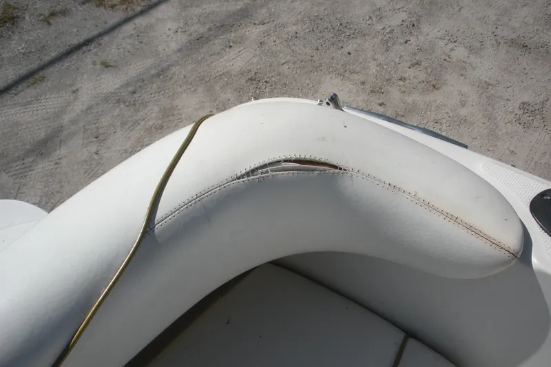 Slide: The Image of Torn white upholstery on 2000 Sea Ray 240 Sundancer boat seat. - 17