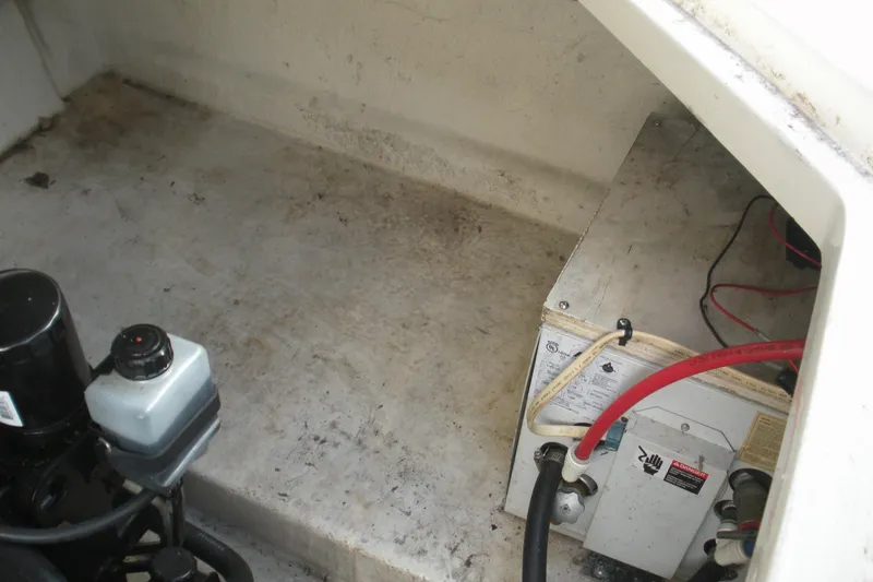 Slide: The Image of Engine compartment of a 2000 Sea Ray 240 Sundancer boat, showing mechanical components. - 18