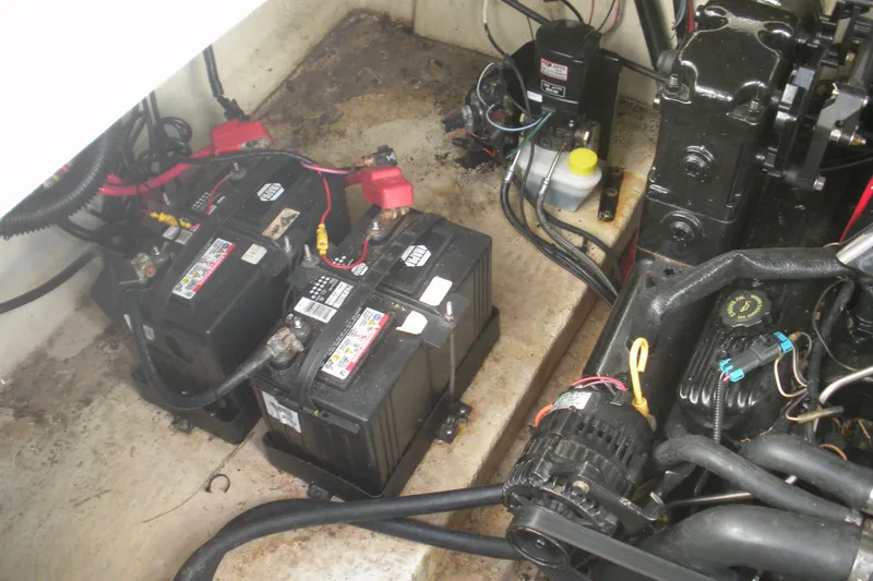 Slide: The Image of Engine compartment of a 2000 Sea Ray 240 Sundancer with batteries and wiring. - 19