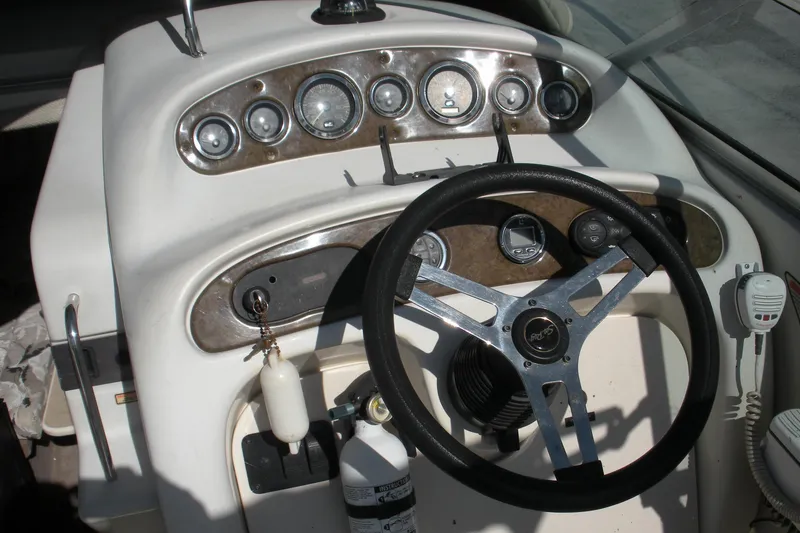 Slide: The Image of Steering console of a 2000 Sea Ray 240 Sundancer boat with gauges and controls. - 9