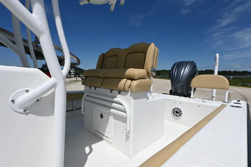 Slide: The Image of 2023 Clark Sound 24 boat interior with tan seating and outboard motor. - 13
