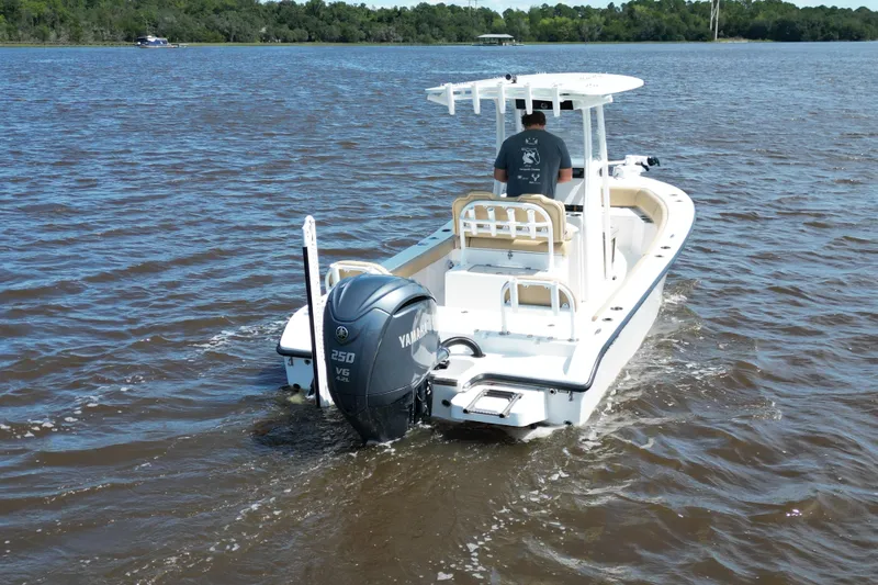 Slide: The Image of 2024 Clark Sound 24 boat with Yamaha 250 V6 engine on a lake. - 2